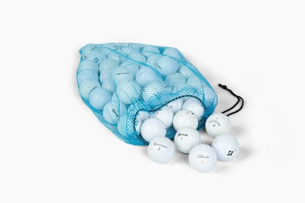 Blue mesh bag filled with premium golf balls from Callaway, Titleist, Srixon, and TaylorMade brands, with some balls spilling onto a flat surface