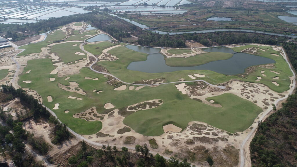 Aerial view of Ballyshear Golf Links near Bangkok showing sandy waste areas, bunkers and a central lake