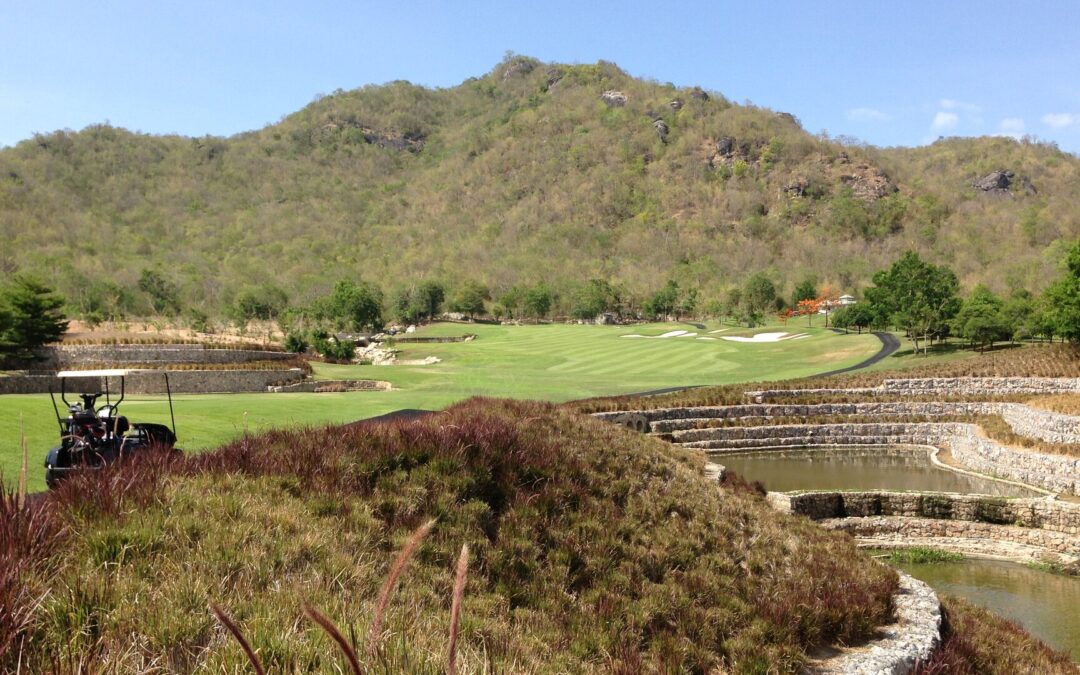 Terraced water features and fairway framed by hills at Black Mountain Golf Club, Hua Hin