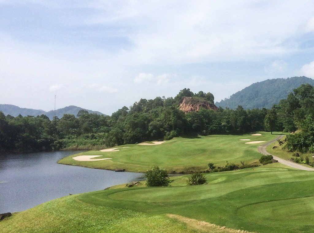 Fairway and bunkers at Red Mountain Golf Club, Phuket, running beside a lake in a former tin mine pit
